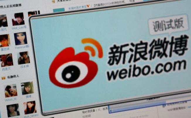 China’s largest e-commerce company is buying the nation's most popular microblogging service. (Reuters/STRINGER)