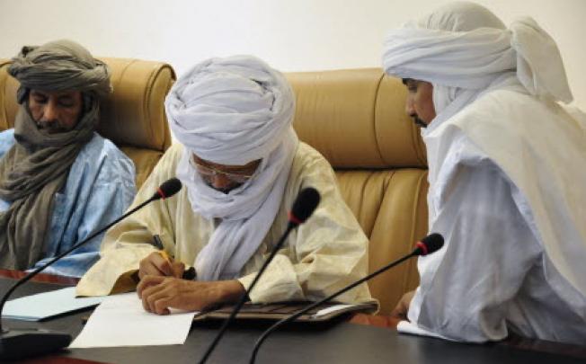 Algabass Ag Intalla, leader of the Ansar Dine delegation (R) attends a meeting with representatives of Mali's Tuareg MNLA group as well as lead negotiator Burkina Faso President Blaise Compaore in Ouagadougou. Photo: AFP