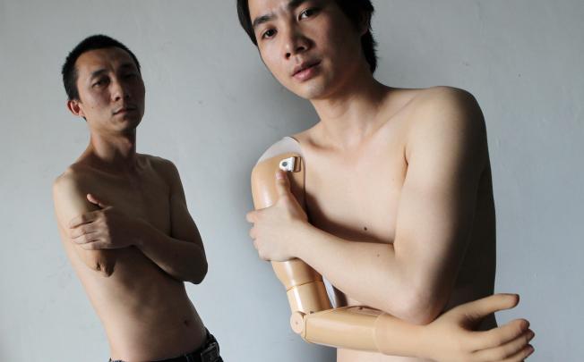 Liang Jun (left), a printing worker, and Li Jiangping, an air-conditioner mechanic, were injured on the job in Foshan. Photo: K.Y. Cheng