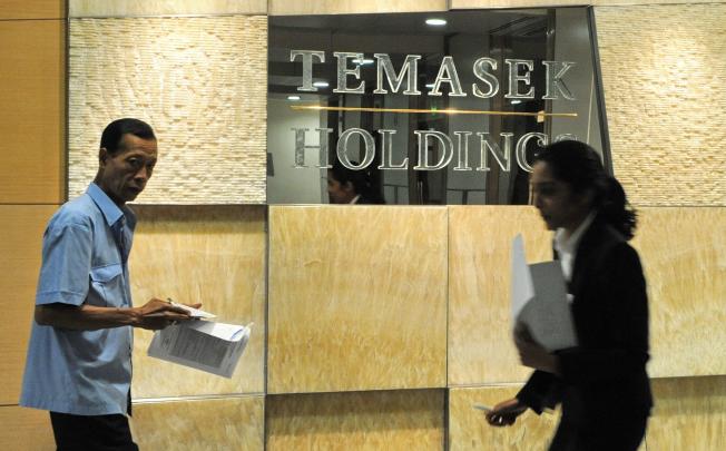 Temasek Holdings, Singapore state-linked investment firm, owns 16 per cent in Olam International. (AFP PHOTO/ROSLAN RAHMAN)