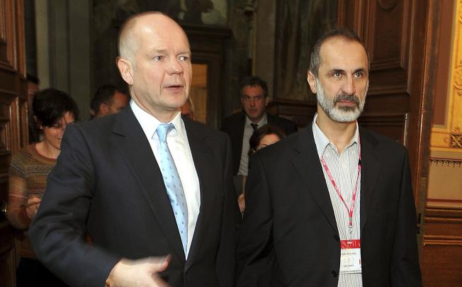 William Hague (left) with newly-formed opposition bloc leader Ahmed Moaz al-Khatib, just before a Whitehall meeting on November 16. Photo: AP
