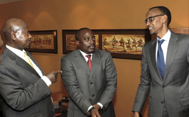 Uganda's President Yoweri Museveni (left) talks with his counterparts Paul Kagame of Rwanda (right) and Joseph Kabila of Congo during a meeting in Kampala, Uganda, on Wednesday. Photo: AP 
