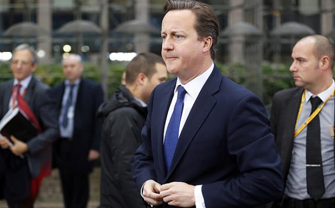 British Prime Minister David Cameron arrives for an EU summit in Brussels on Friday. Photo: AFP 