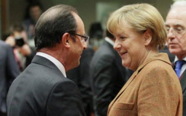 German Federal Chancellor Angela Merkel and French President Francois Hollande at the start of a European summit at the EU headquarters in Brussels on Thursday. Photo: EPA