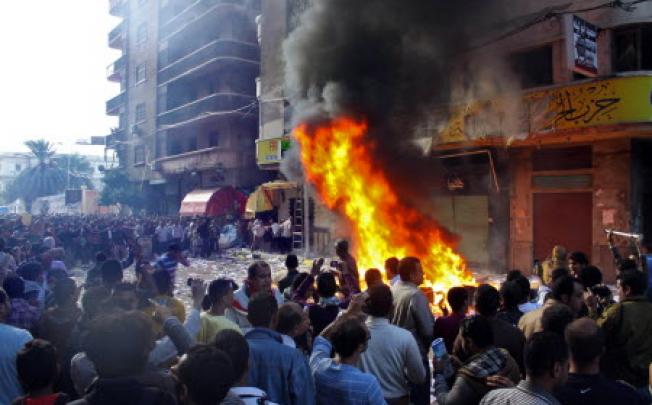 Protesters storm an office of Egyptian President Mohammed Morsi's Muslim Brotherhood Freedom and Justice party and set fires in Alexandria, Egypt. Photo: AP