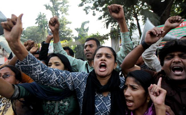 Bangladeshi garment workers shout slogans during a protest in Dhaka on Tuesday, following a deadly fire in a garment factory. Photo: AFP