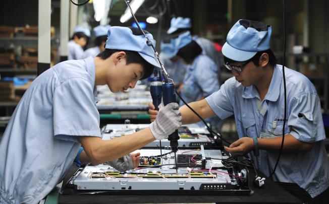 Chinese workers labouring on a television set assembly line in a factory in Shenyang in Liaoning Province on August 27, 2012. Photo: EPA 