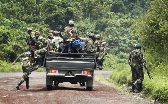 Congolese M23 rebel fighters dismount as they look for FDLR (Force Democratique de Liberation du Rwanda) returning from an incursion into Rwanda on Tuesday. Photo: AP 