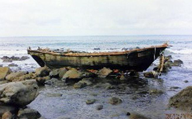A wooden boat containing several rotting bodies and with Korean characters on its side was found on Sado island in Niigata prefecture, northern Japan. Photo: AFP
