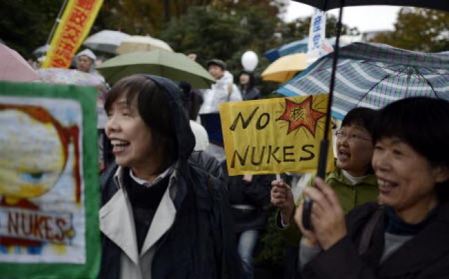 Protesters hold placards during a large anti-nuclear power rally in front of the National Diet Building in Tokyo in Japan. Photo: EPA