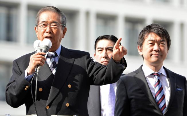 Former Tokyo Governor and Japan Restoration Party leader Shintaro Ishihara (left) delivers a speech, while Osaka Mayor and Japan Restoration Party co-leader Toru Hashimoto (right) looks on. Photo: AFP