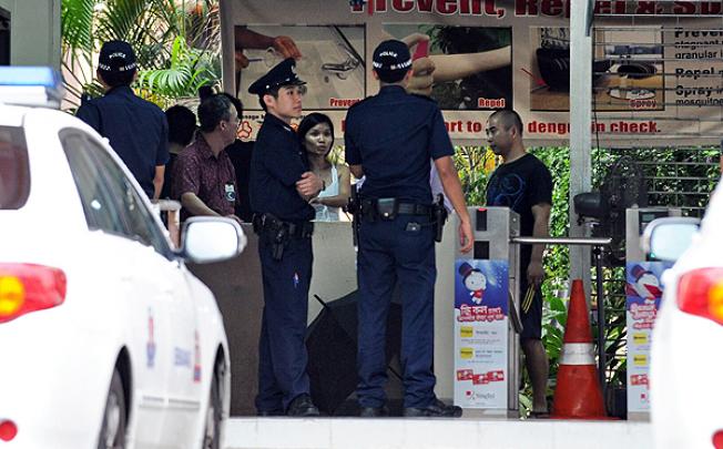 Singapore police make inquiries at a foreign workers dormitory. Photo: AFP 