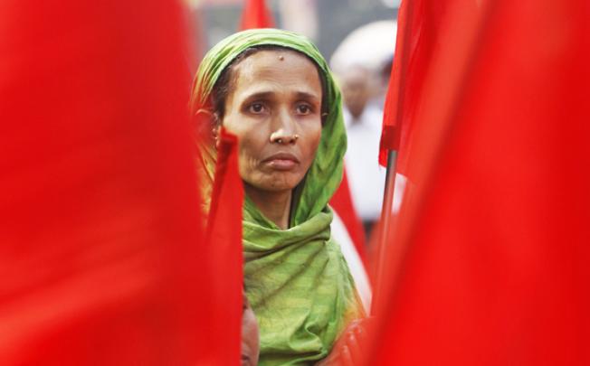 A Bangladeshi garment worker participates in a protest to mourn the death of the victims of a fire in a garment factory in Dhaka on Friday. Photo: AP 