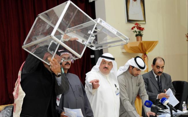 Elections officials count votes for the parliamentary election after a polling station closes in Kuwait City. Photo: EPA