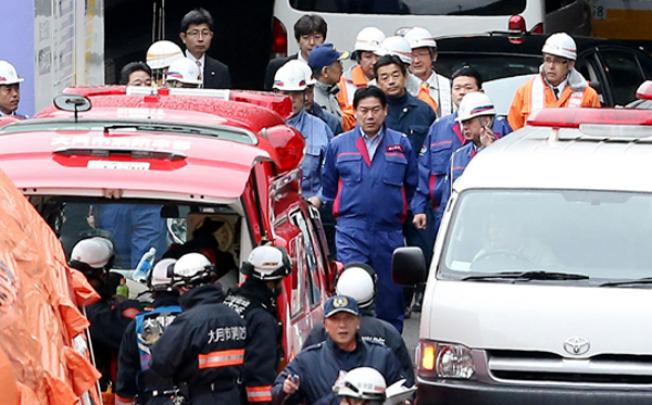Japanese Transport Minister Yuichiro Hata (centre) inspects the scene at the Sasago tunnel road a wall collapsed near Otsuki, 80km west of Tokyo. Photo: AFP