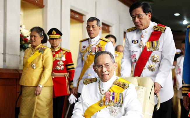 Thai King Bhumibol Adulyadej departs Siriraj hospital to grant an audience on his 85th birthday celebrations in Bangkok on Wednesday. Photo: EPA