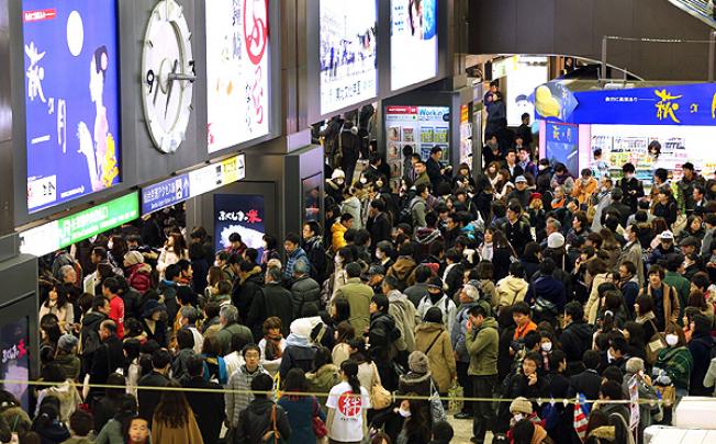  Passengers wait at Sendai railway station after trains were stopped when a powerful earthquake hit Miyagi prefecture, northeastern Japan, on Friday. Photo: AFP