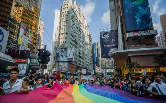 Participants carry a large flag as they take part in a Gay Pride procession in Hong Kong on November 10, 2012.Photo: AFP