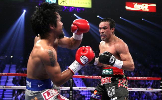 Juan Manuel Marquez ended the fight with an overhand right that hit the advancing Manny Pacquiao flush, sending him down hard. Photo: AFP