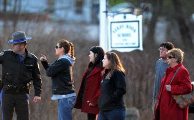 Family members of students of the Sandy Hook Elementary School get updated information from the police after the fatal school shooting in Newtown, Connecticut. Photo: Xinhua