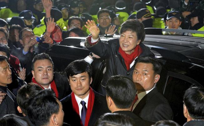 Park Geun-hye waves to supporters as she arrives at the headquarters of the ruling Saenuri party in Seoul last night after becoming South Korea’s new president. Photo: Reuters