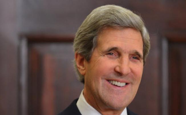Senator John Kerry smiles as US President Barack Obama announces him as his choice for the next secretary of state. Photo: AFP