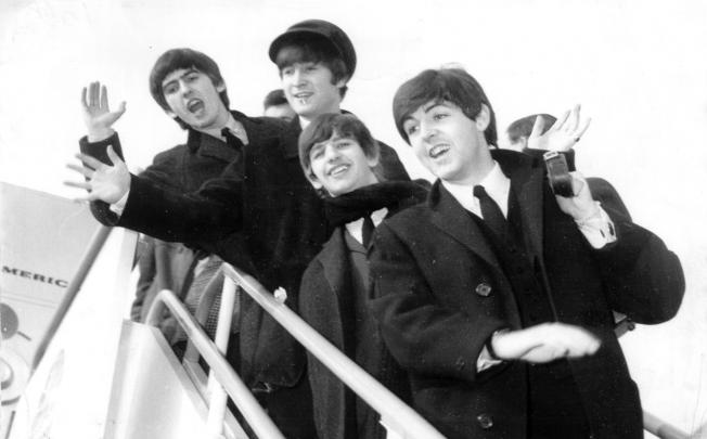 The Beatles arrive in the US for their first visit in 1964.