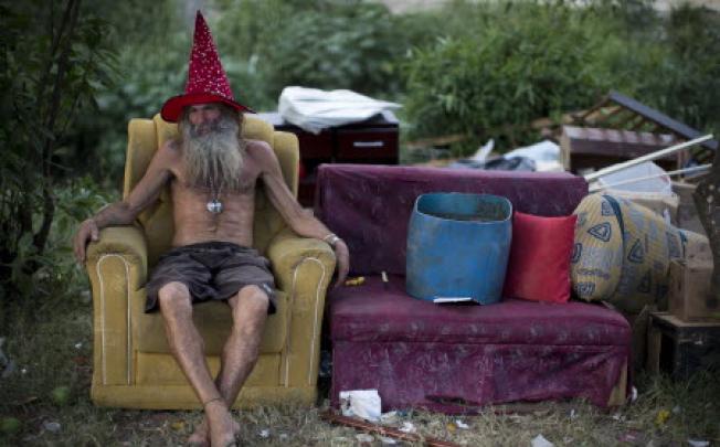 Former soldier Bobo sits on an armchair after collecting recyclables at a slum in Rio de Janeiro in Brazil. Photo: AP