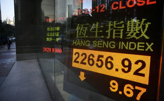 The benchmark Hang Seng Index closed 9.67 points lower to finish at 22,656.92 on turnover of 3.71 billion USD in half-day trade ahead of the New Year break. Photo: AFP