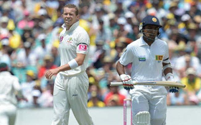 Australia's Peter Siddle reacts after being hit for four by Sri Lanka's Mahela Jayawardene on day one of the sixth test, Australia v Sri Lanka in Sydney on Thursday. Photo: EPA