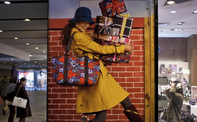 A display poster promoting fashion products at a shopping centre in Beijing. The mainland is moving towards a consumption-driven economy through urbanisation. Photo: AP
