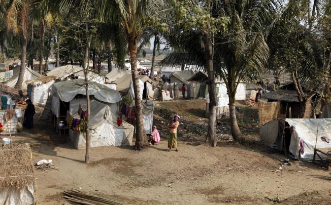 Muslim refugees stand near their tents in Awetawgyi refugee camp in Sittwe, Rakhine State, western Myanmar. Photo: AP