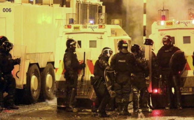 Northern Ireland riot police officers confront Pro-British Loyalists who were launching fireworks, petrol bombs and rocks at Newtownabbey in Northern Ireland. Photo AFP