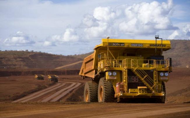 Tipper trucks operating at a Rio Tinto iron ore mine in Western Australia. Photo: Reuters
