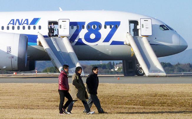 Passengers exit an ANA 787 Dreamliner plane that made an emergency landing at Takamatsu airport in Japan on Wednesday. Photo: Reuters