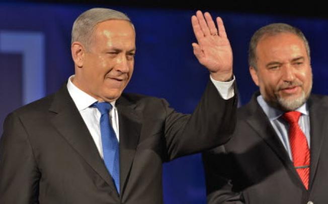 Israeli Prime Minister and the leader of Likud Benjamin Netanyahu (left) and the Leader of Yisrael Beiteinu Avigdor Lieberman greet supporters in Tel Aviv on Tuesday. Photo: Xinhua
