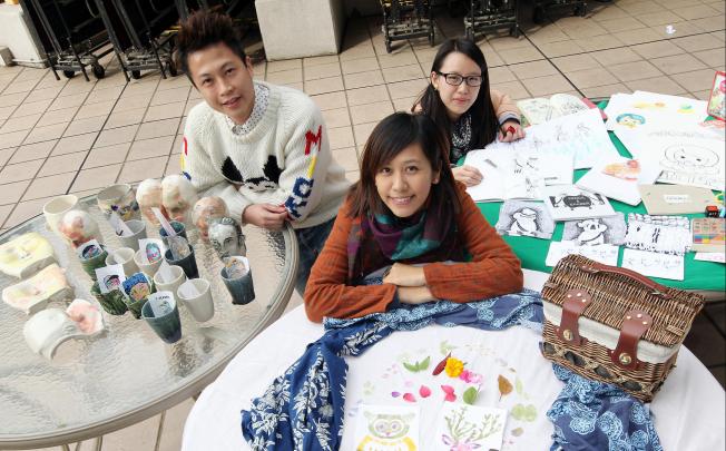 Scott Chan (left), Helen Kwok (centre) and Lyann Chan with some items they have made for exchange at YMCA's DIY Art Appreciation Stalls. Photo: David Wong