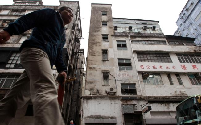 A man walks past an old factory building in Tai Kok Tsui. Photo: David Wong