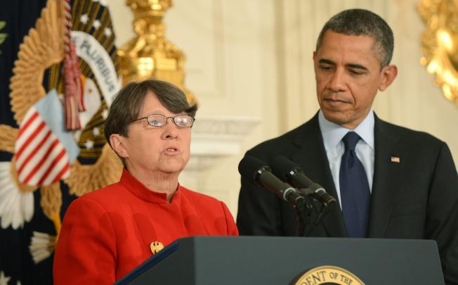 US President Barack Obama (right) listens as Mary Jo White, his nominee to be the next chair of the Securities and Exchange Commission delivers remarks. Photo: EPA