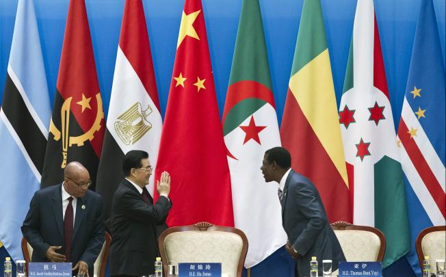 Chinese President Hu Jintao, center, gestures to Benin's President Thomas Yayi Boni, right, as South African President Jacob Zuma looks on at the 5th Ministerial Conference of the Forum on China-Africa Cooperation. Photo: AP
