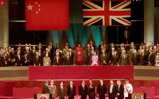 Leaders of China (left) and Britain stand to attention following the hoisting of the Chinese flags at the handover ceremony in 1997. Photo: Reuters