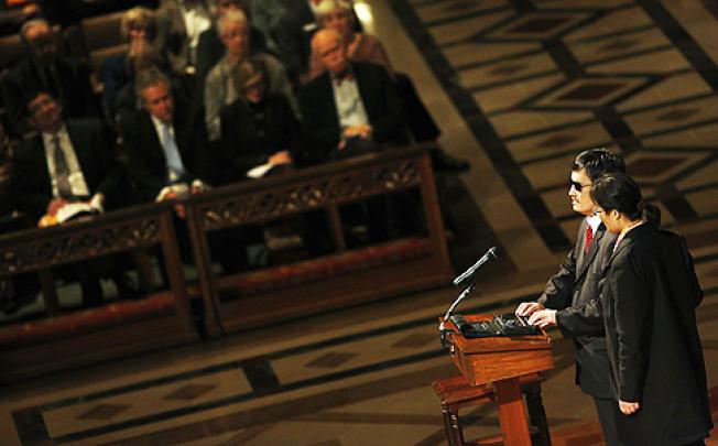 Chen Guangcheng, with his wife Yuan Weijing, delivers remarks at the National Cathedral in Washington. Photo: Reuters