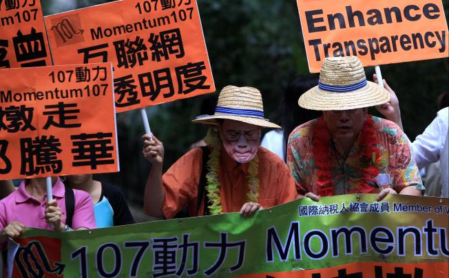 Members of Momentum 107 march to the old Central Government offices to stage a street parody of Donald Tsang and Edward Yau, urging them to step down back in June last year. Photo: Jonanthan Wong