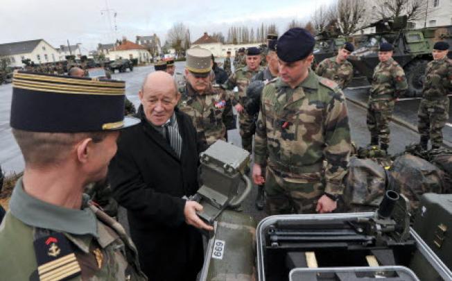 French defence minister Jean-Yves Le Drian (2nd Left) meets soldiers from the third RIMA (Marine Infantry Regiment) on Tuesday in Vannes, France. Photo: AFP