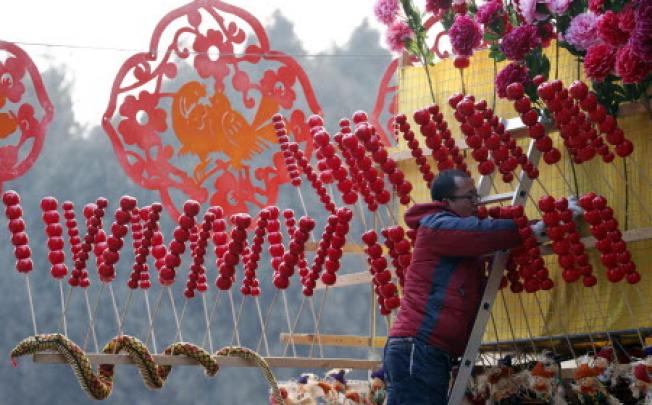 A snake-shaped doll is displayed at a shop during the temple fair in Ditan Park, also known as the Temple of Earth, in Beijing on Saturday. Photo: AP