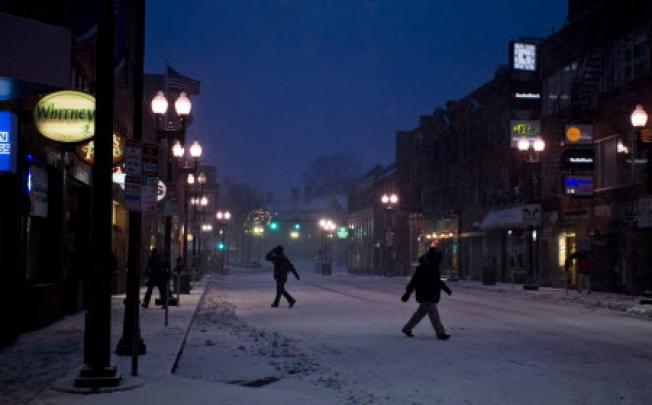 Pedestrians cross street amid wind and snow in Cambridge, Massachusetts, US. Photo: EPA