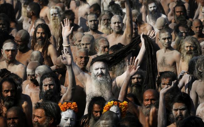 Indian Hindu holy men, some covered in ash, walk in procession after bathing at Sangam, the confluence of the Ganges. Photo: AP
