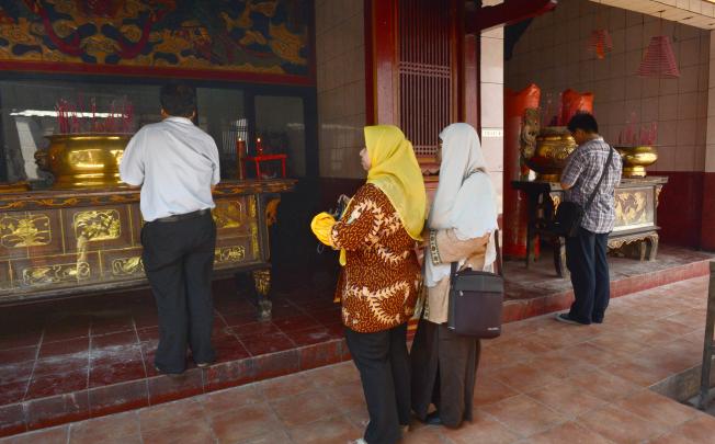 Two Muslim women visit a Buddhist temple in Jakarta. Photo: AFP