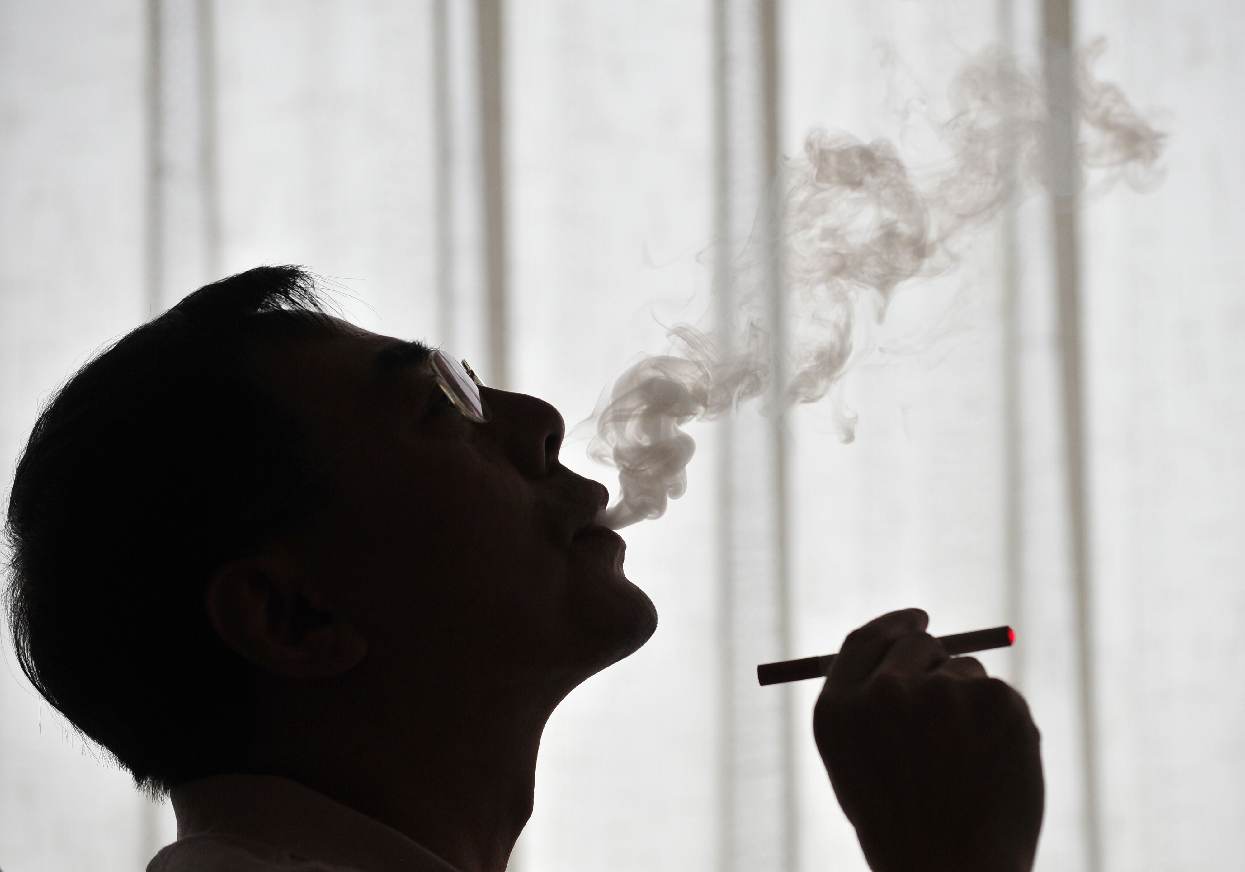 The inventor of the electronic cigarette, Hon Lik, smoking his invention in Beijng in 2009. Photo: AFP