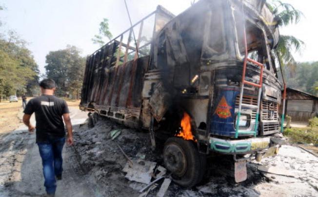 The wreckage of a truck following violence in Goalpara, some 135km from Guwahati. At least 11 people have been killed in clashes between police and tribal groups there. Photo: AFP